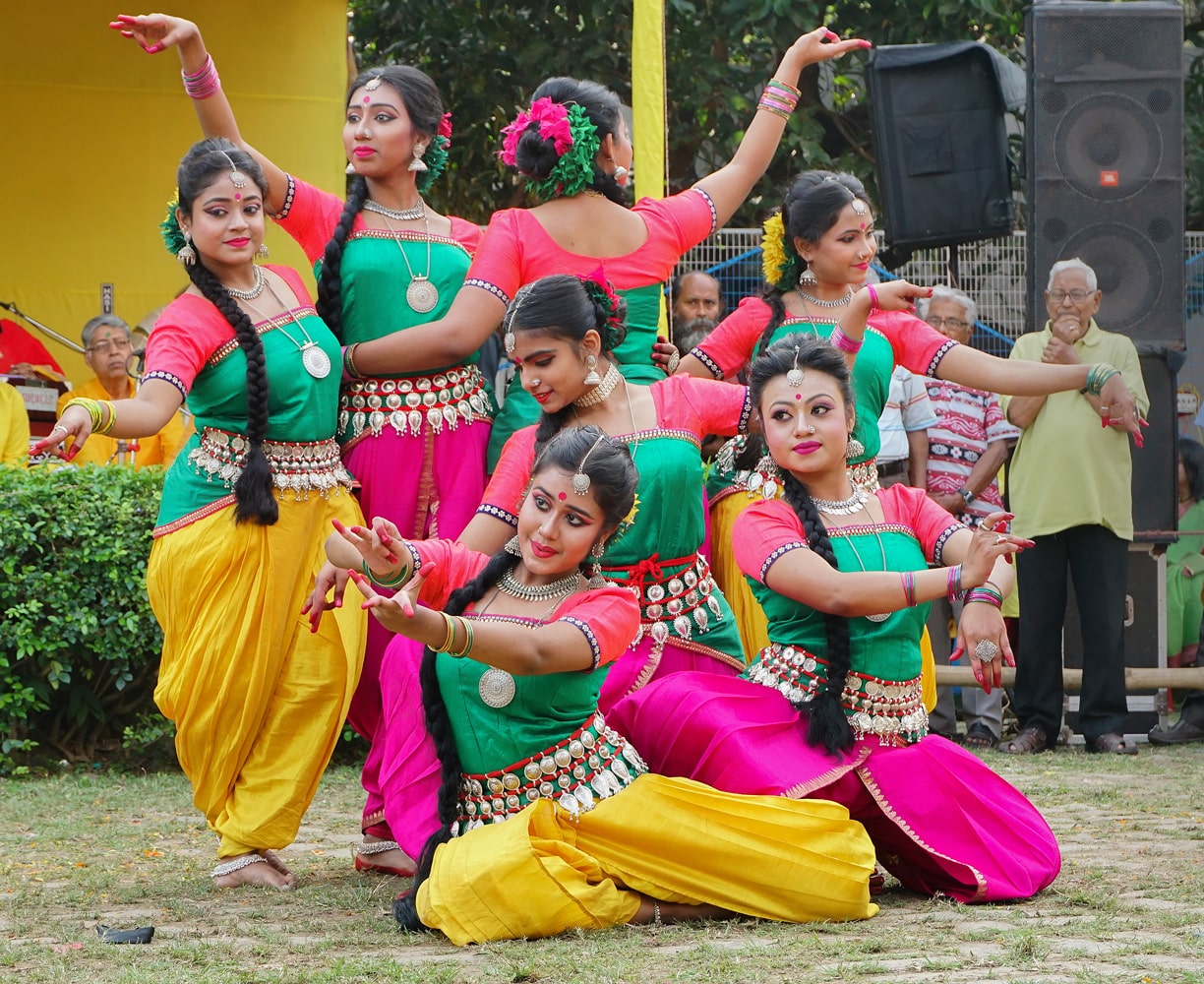 Kolkata-West Bengal-India-Smiling young Bengali girl dancers dressed in colorful Indian dresses-dancing at Dol utsab or Holi festival Celebration of spring in India
